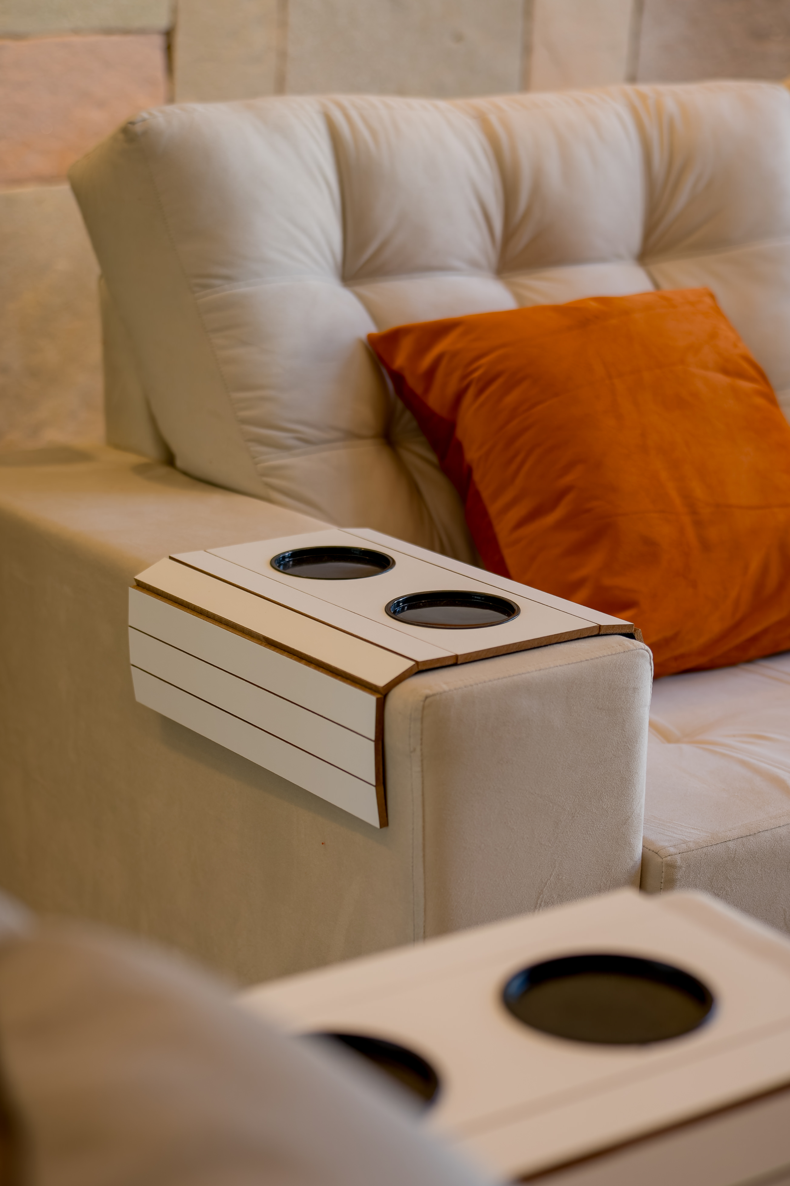 Arm of sofa with drinks holders
